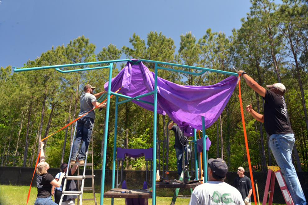 Building the Playground Equipment Putting the awning on the playground equipment.
