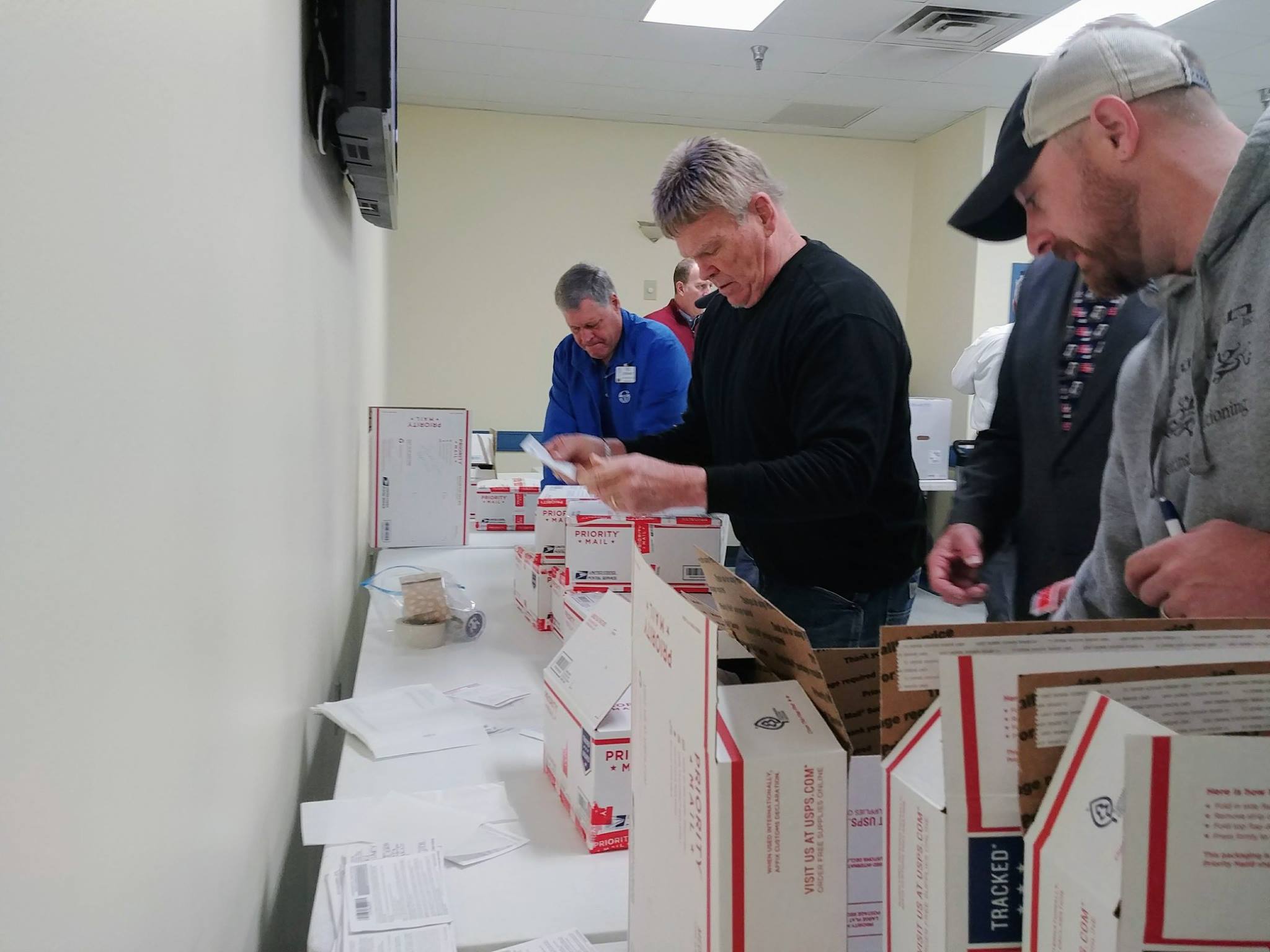 Label & Seal Clayton Rotarians putting on the address labels and sealing the boxes.