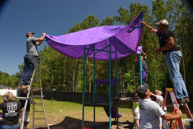 Building the Playground Equipment Putting the awning on the playground equipment.