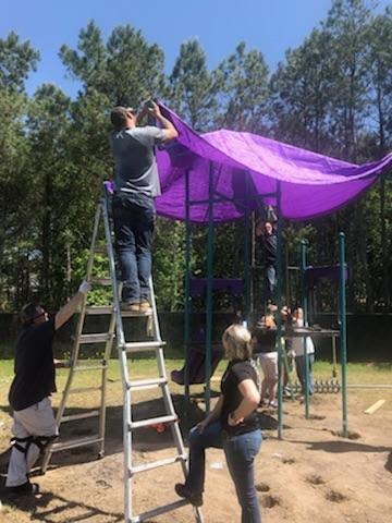 Building the Playground Equipment Putting the awning on the playground equipment.