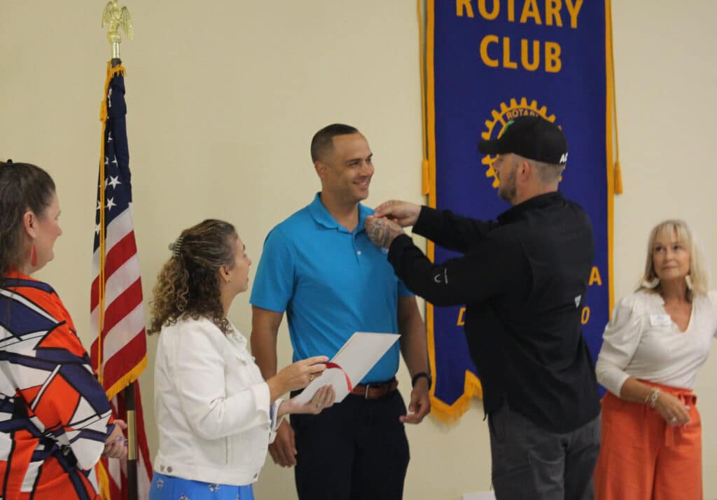 New Member Garrick Locklear receives his Rotary Pin from President Randy Berry - 09.19.2024
